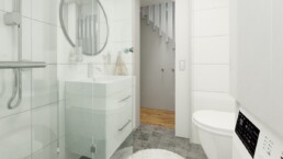 Ett ljust badrum med vit rund matta