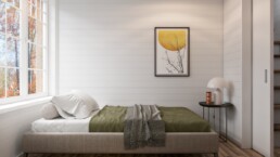 En säng med en tavla på väggen